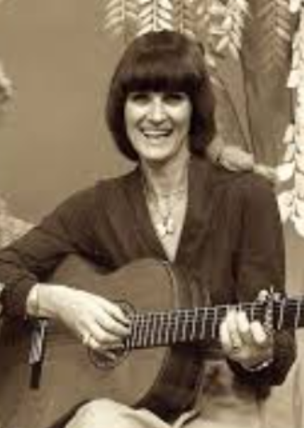 Photo of Patsy Bisco playing the guitar