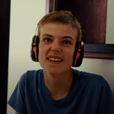 Close up photo of Patrick Saunders wearing headphones