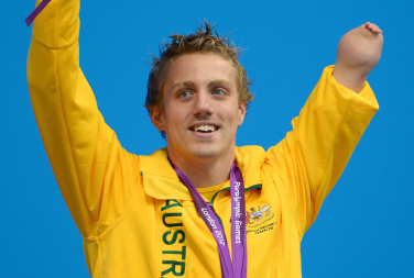 hoto of Matthew Cowdrey wearing his Australian sports gear with a medal round his neck