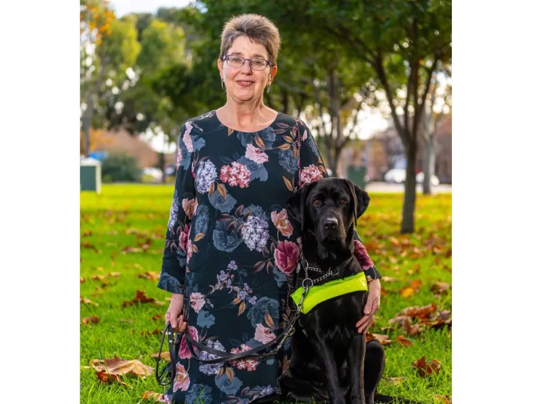 Photo of Annette Holden with her guide dog