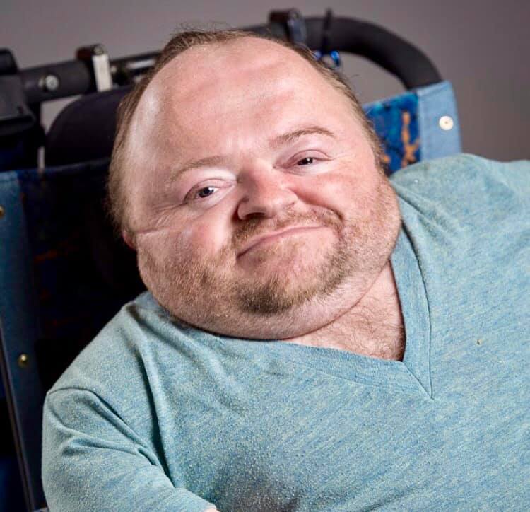A close up photo of Quentin Kenihan in his wheelchair